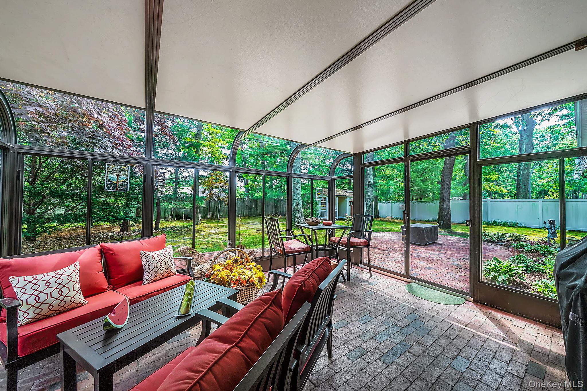 96 Fulton Boulevard Commack, NY 11725 - Photo 28 of 41 a living room with furniture and floor to ceiling windows