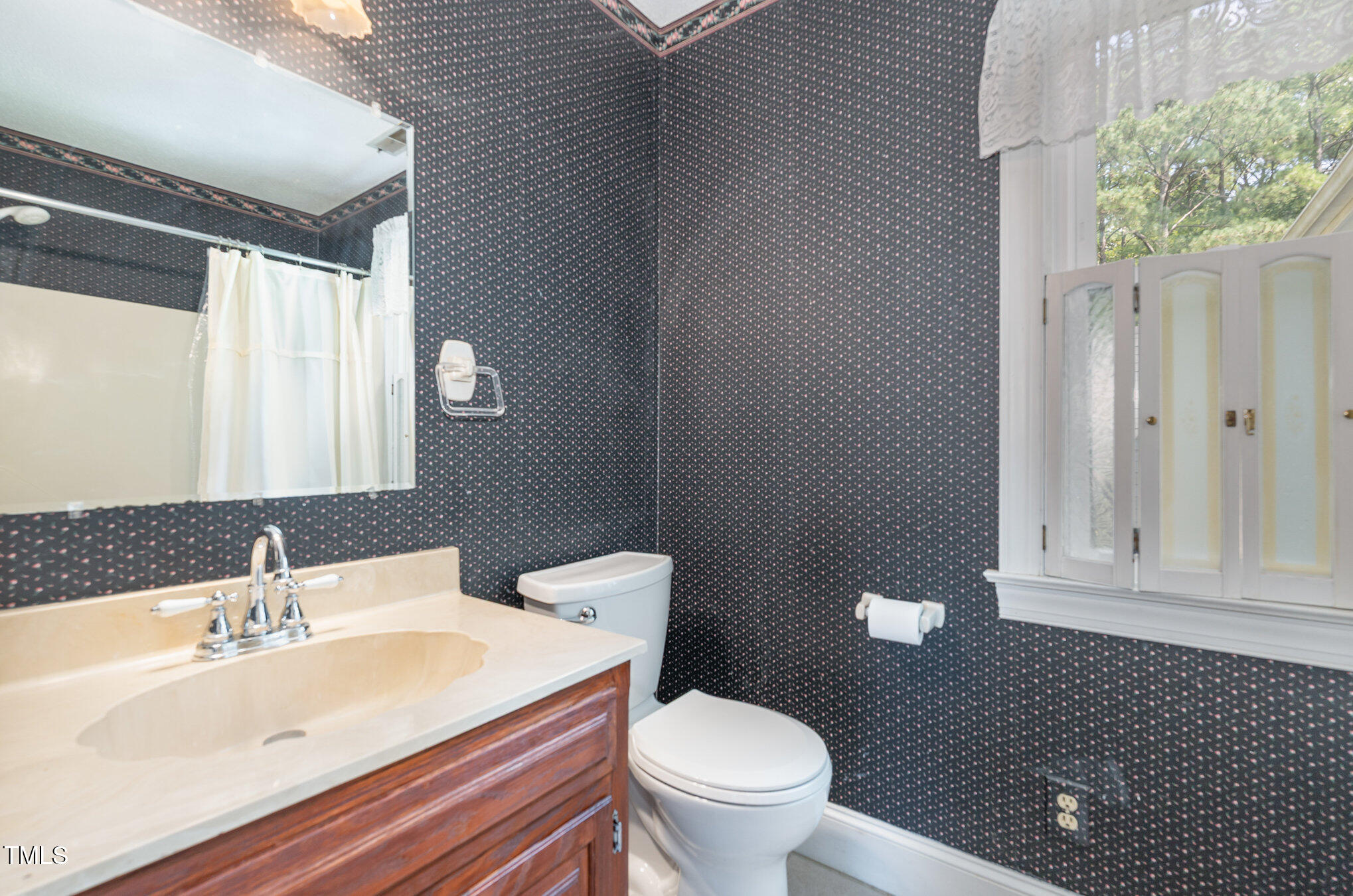 2601 Forestville Road Wake Forest, NC 27587 - Photo 12 of 25 a bathroom with a sink a toilet and a mirror