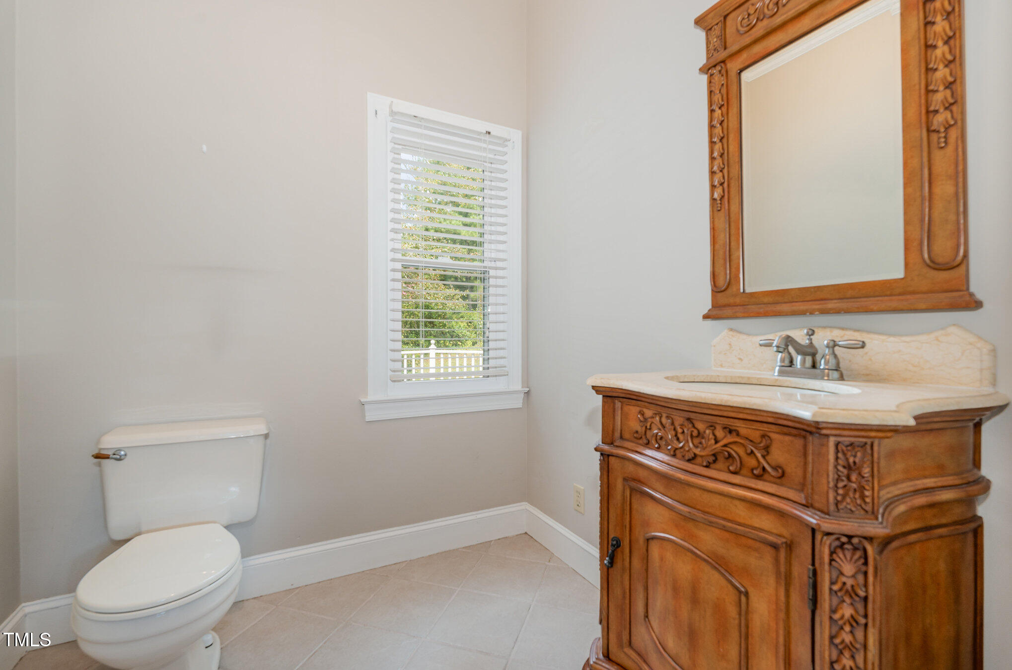 2601 Forestville Road Wake Forest, NC 27587 - Photo 19 of 25 a bathroom with a sink a toilet and a mirror