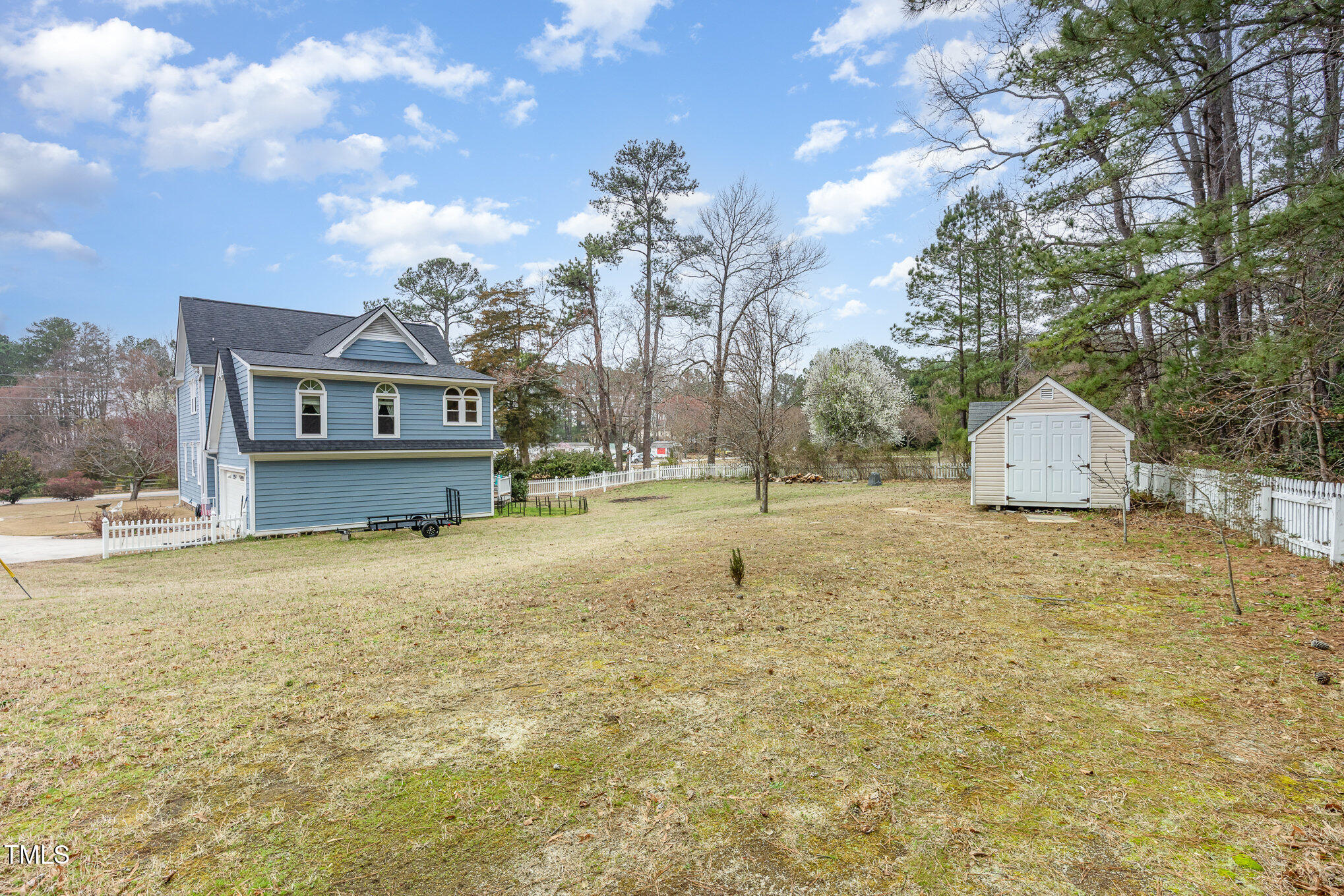 2601 Forestville Road Wake Forest, NC 27587 - Photo 21 of 25 a house with trees in front of it