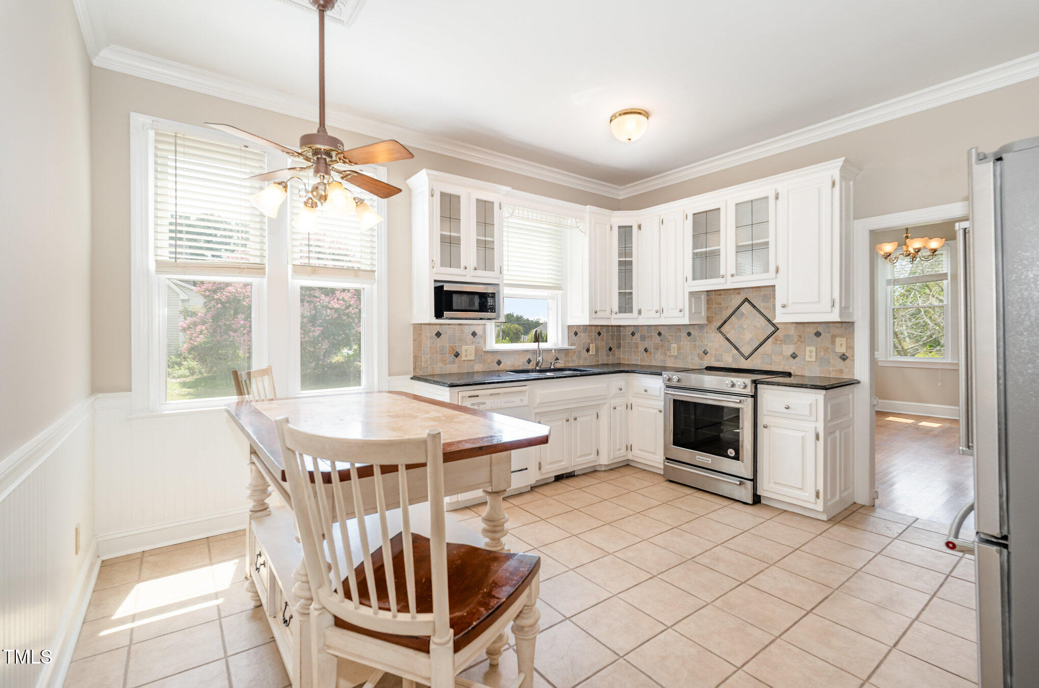 2601 Forestville Road Wake Forest, NC 27587 - Photo 5 of 25 a kitchen with granite countertop a sink stainless steel appliances and white cabinets