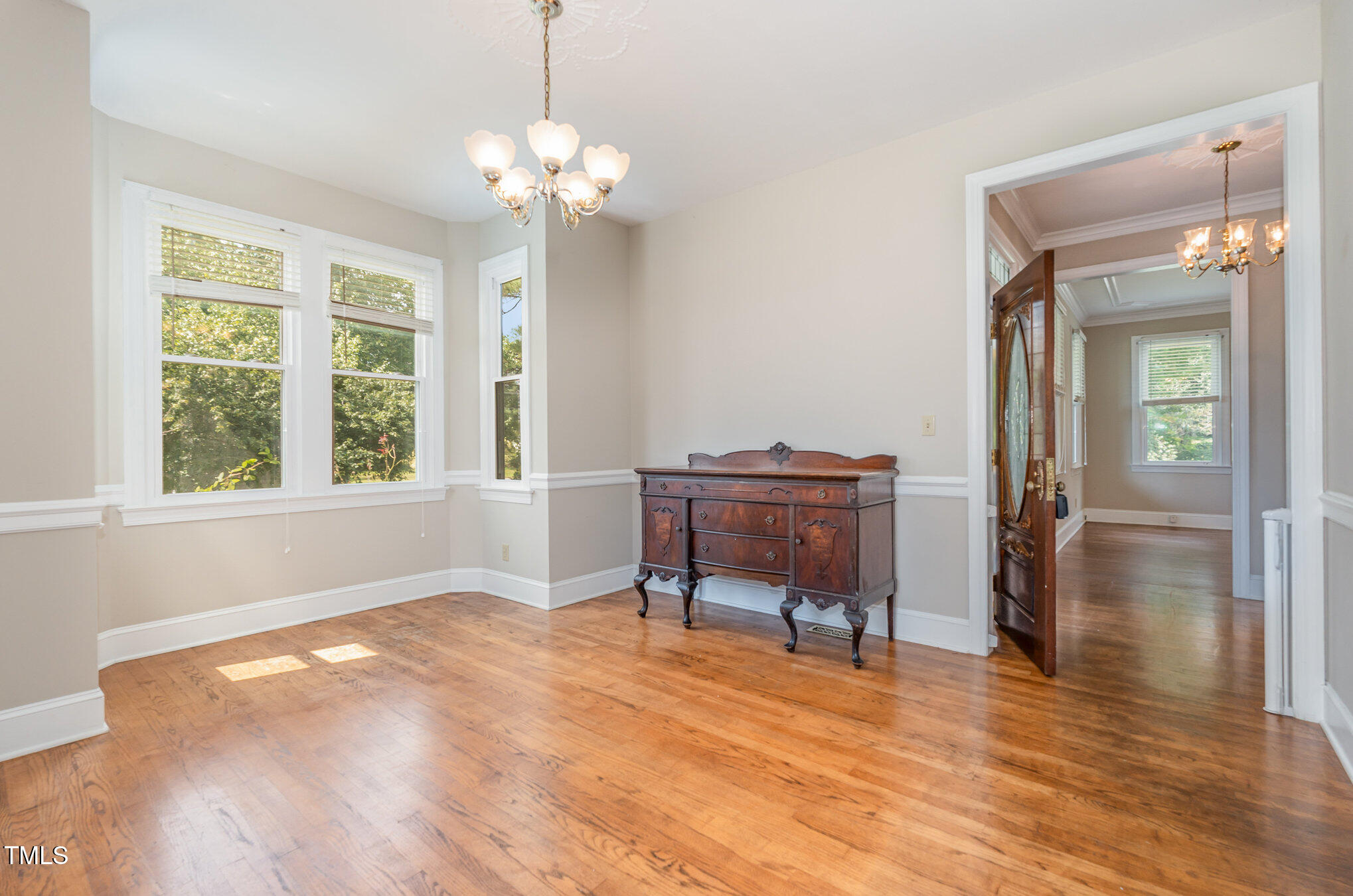 2601 Forestville Road Wake Forest, NC 27587 - Photo 8 of 25 a dining room with chandelier and wooden floor