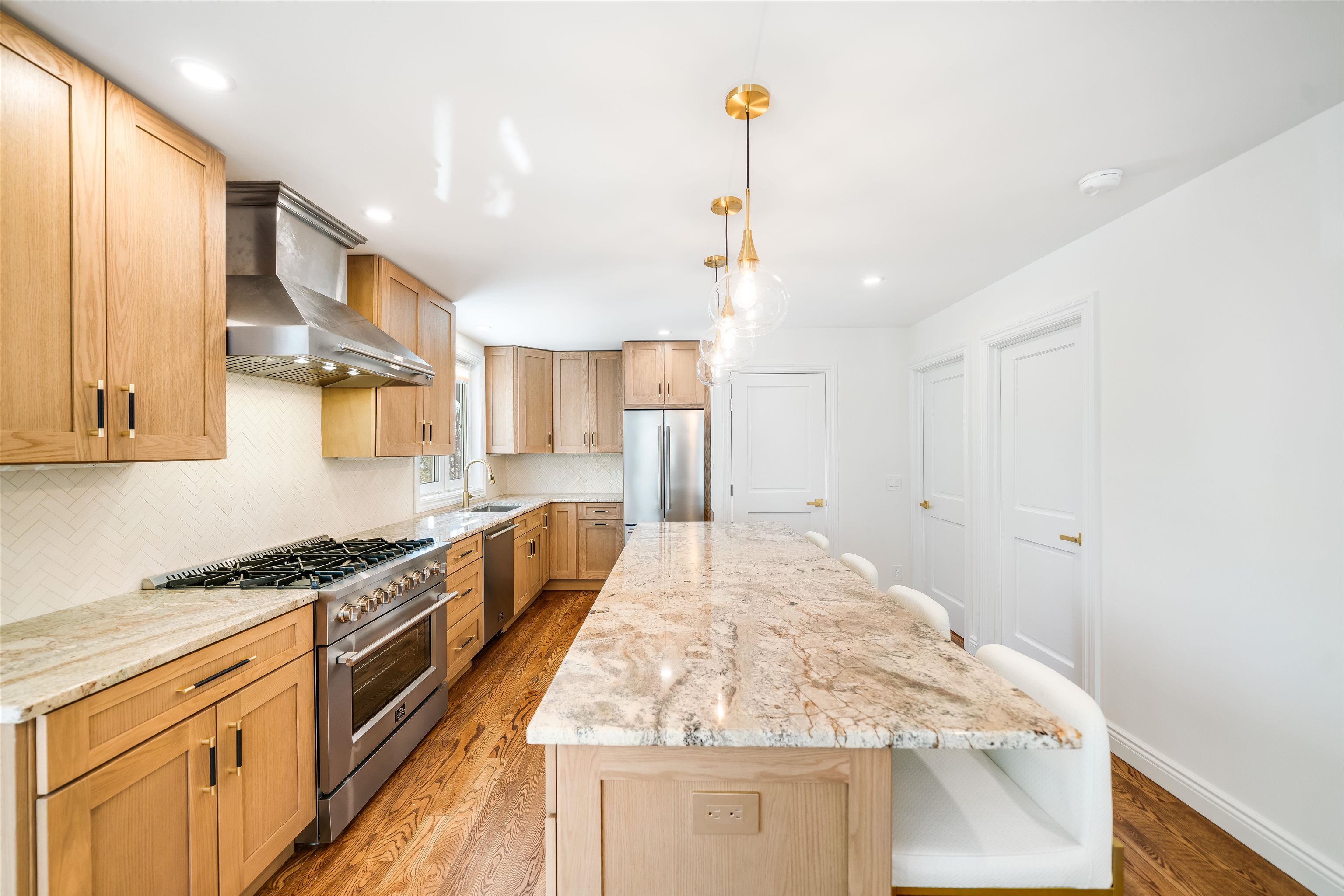 11 Walnut Street, Unit 1 Little Falls, NJ 07424 - Photo 2 of 24 a kitchen with stainless steel appliances granite countertop a sink and stove