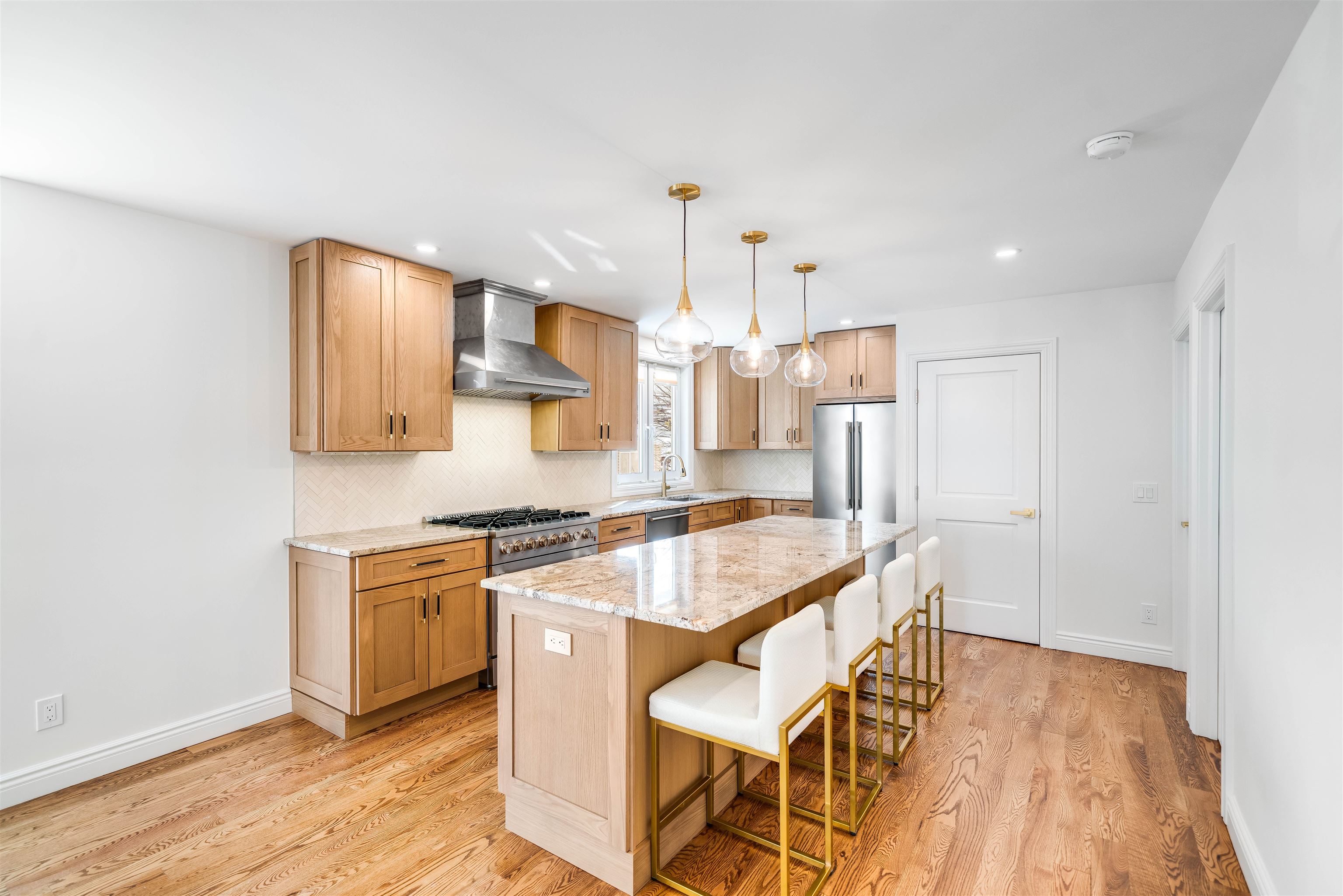 11 Walnut Street, Unit 1 Little Falls, NJ 07424 - Photo 3 of 24 a kitchen with stainless steel appliances granite countertop a stove a sink dishwasher and a refrigerator with wooden floor