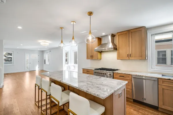 a kitchen with stainless steel appliances granite countertop a sink a stove a oven a counter space and cabinets