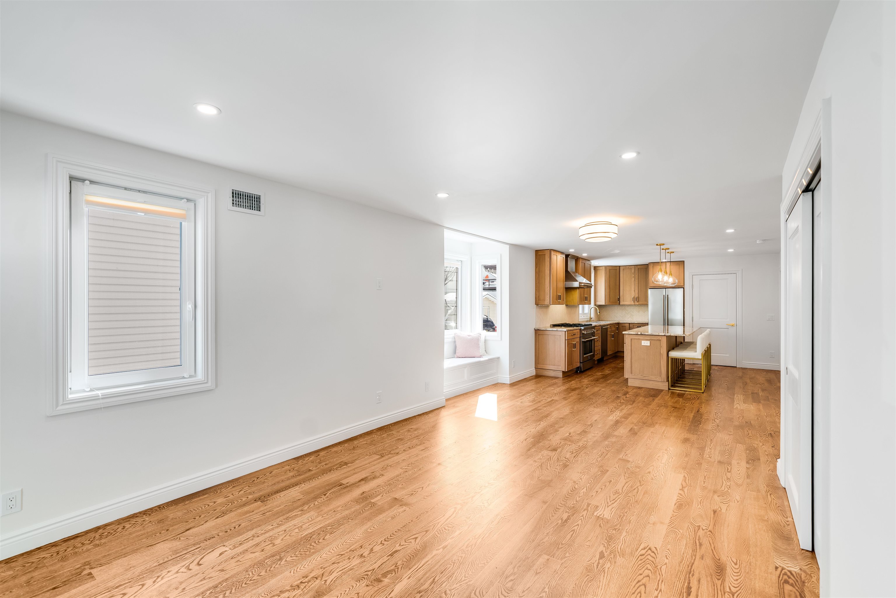 11 Walnut Street, Unit 1 Little Falls, NJ 07424 - Photo 7 of 24 a view of an empty room with wooden floor and a window