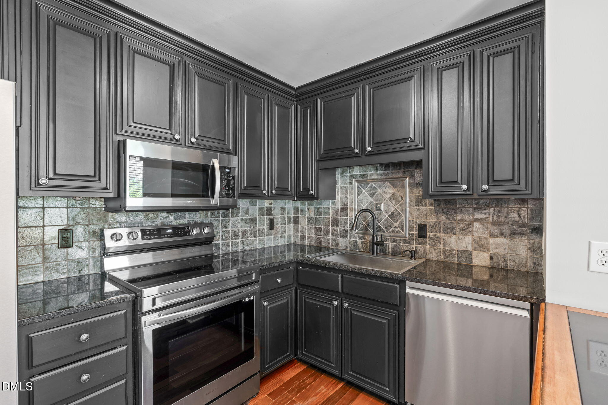 2208 Stafford Avenue Raleigh, NC 27607 - Photo 9 of 30 a kitchen with stainless steel appliances granite countertop a stove microwave and cabinets