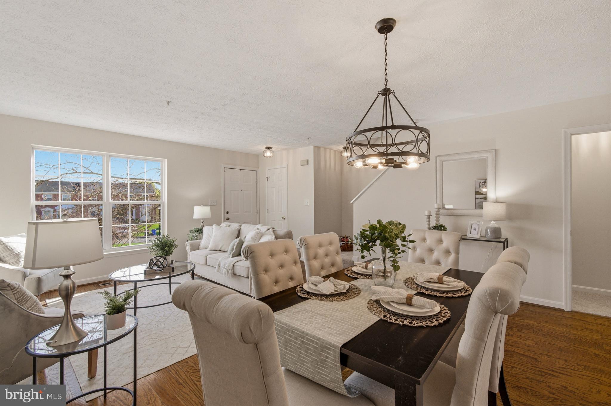 9054 Constant Course Columbia, MD 21046 - Photo 19 of 61 a dining room with furniture a chandelier and wooden floor