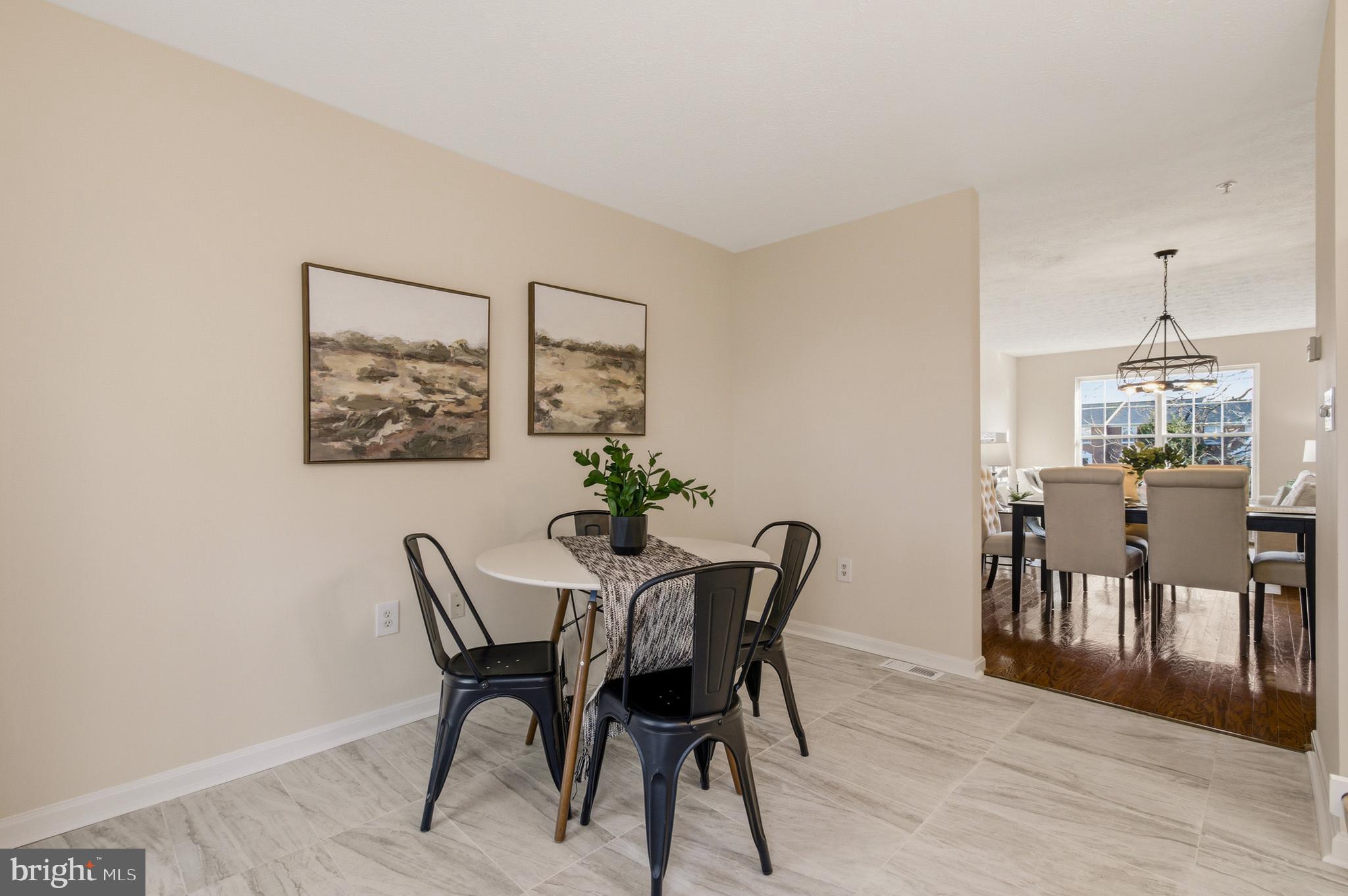 9054 Constant Course Columbia, MD 21046 - Photo 27 of 61 a view of a dining room with furniture and wooden floor
