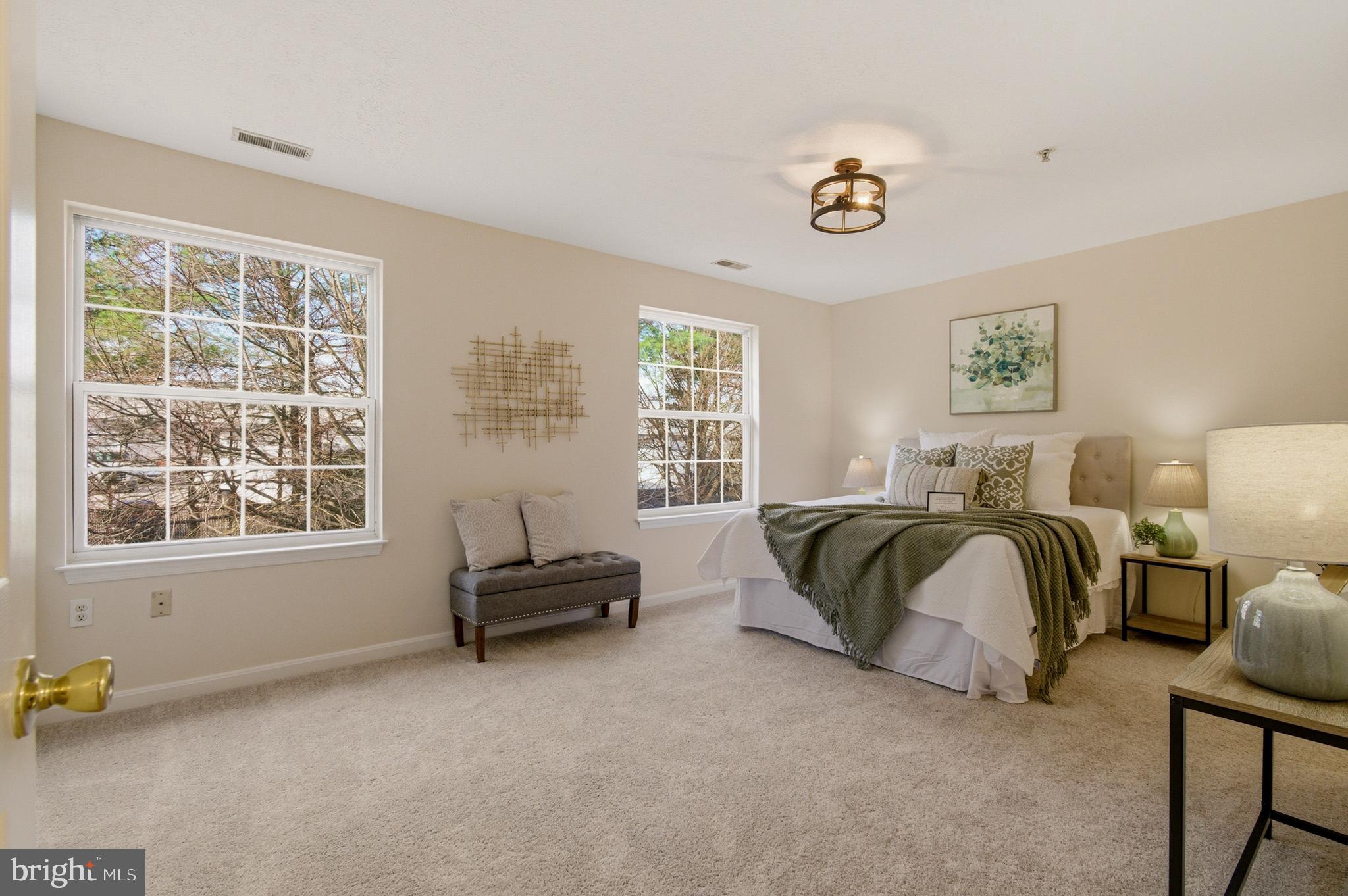9054 Constant Course Columbia, MD 21046 - Photo 50 of 61 a spacious bedroom with a bed and a window