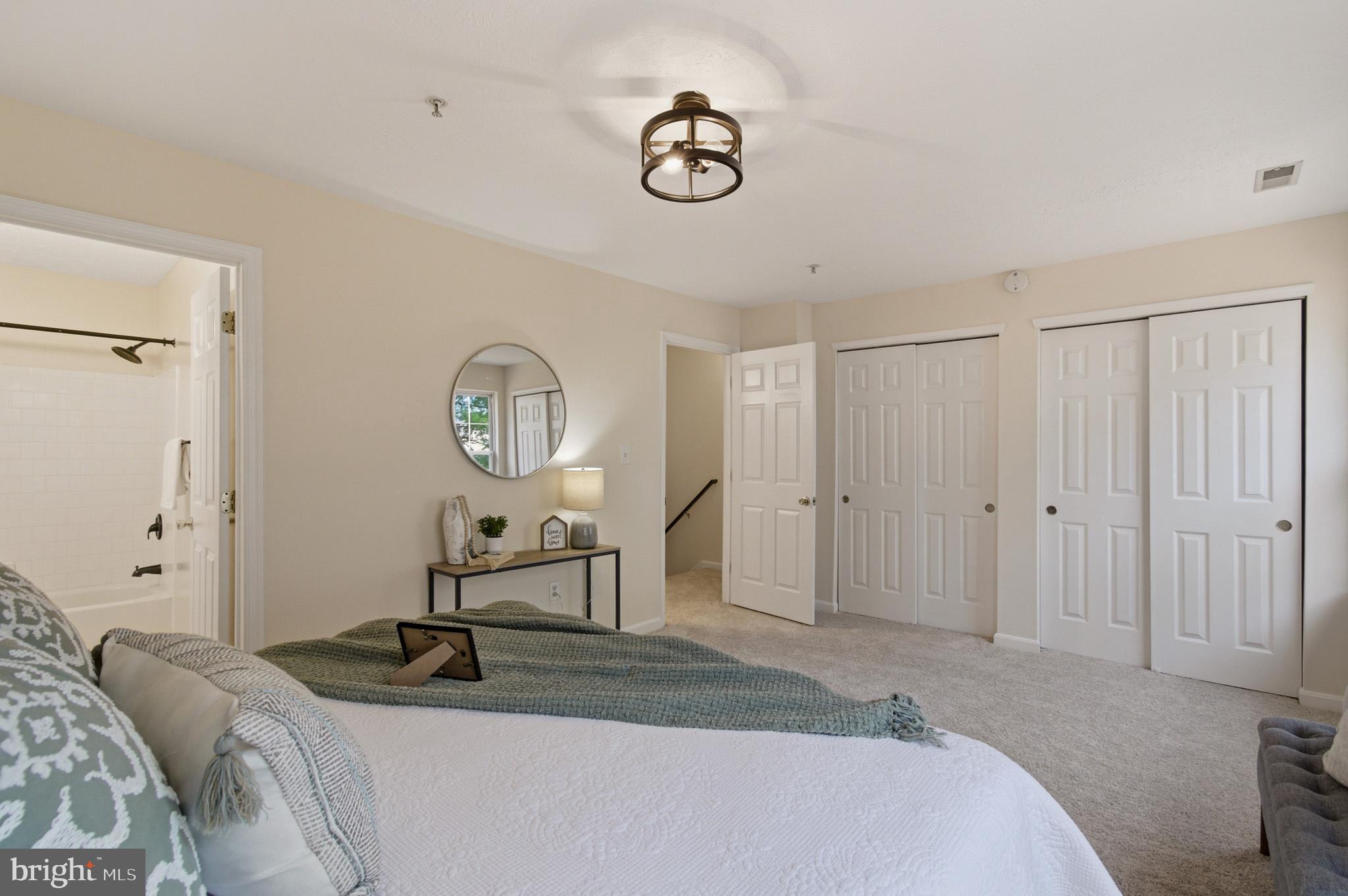 9054 Constant Course Columbia, MD 21046 - Photo 54 of 61 a bed room with a bed and a chandelier