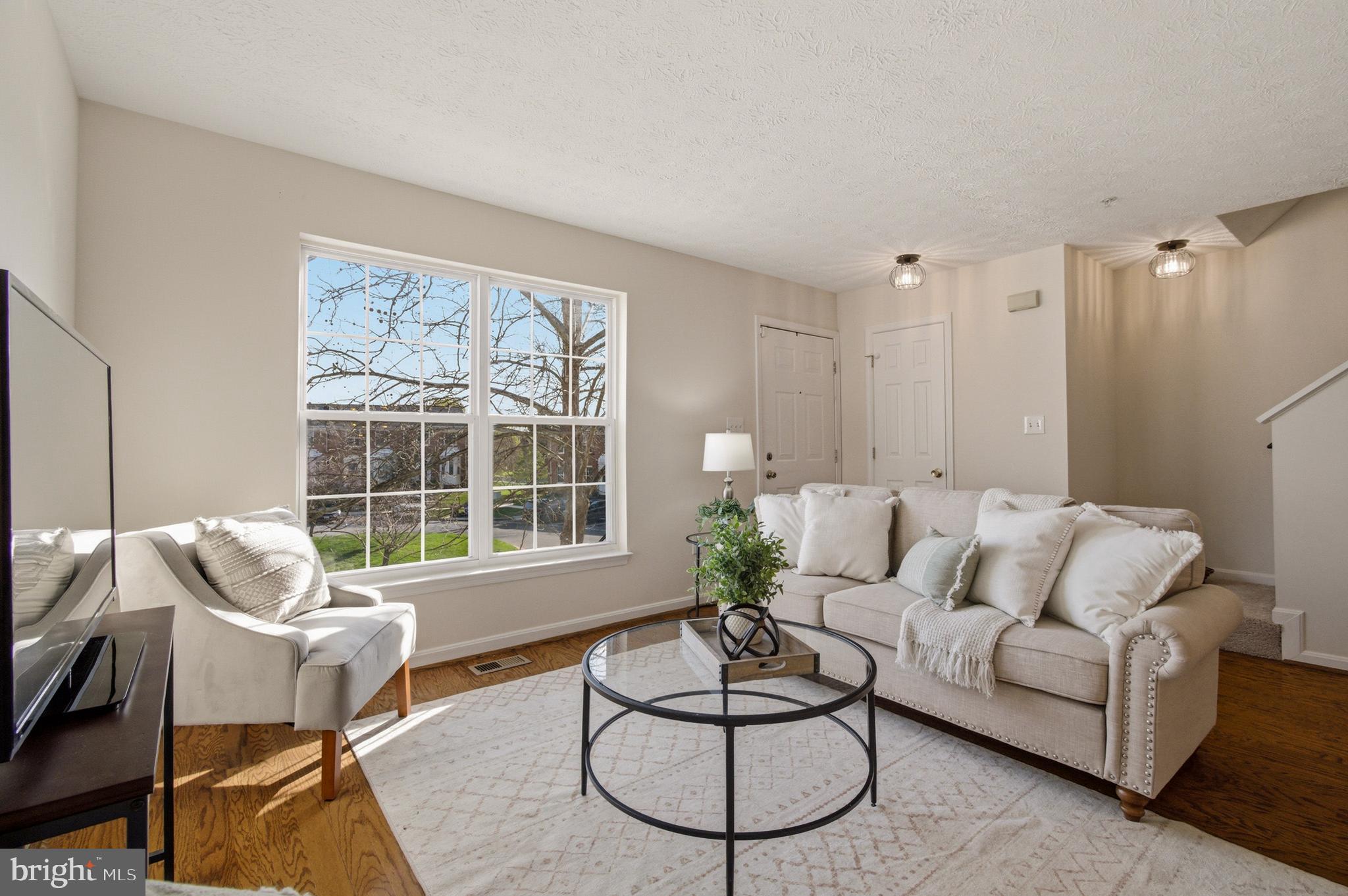 9054 Constant Course Columbia, MD 21046 - Photo 10 of 61 a living room with furniture and a large window