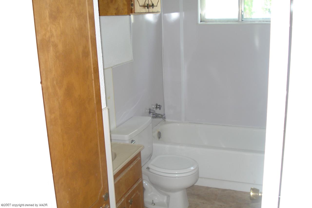 4202 Cline Road Amarillo, TX 79110 - Photo 4 of 7 a bathroom with a shower and a toilet