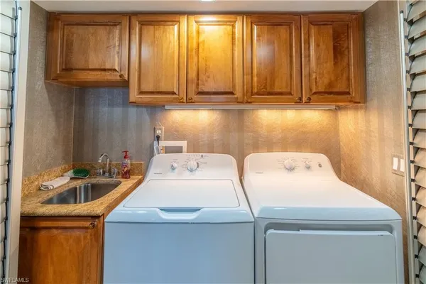 a view of a kitchen with stainless steel appliances granite countertop a stove a sink and dishwasher