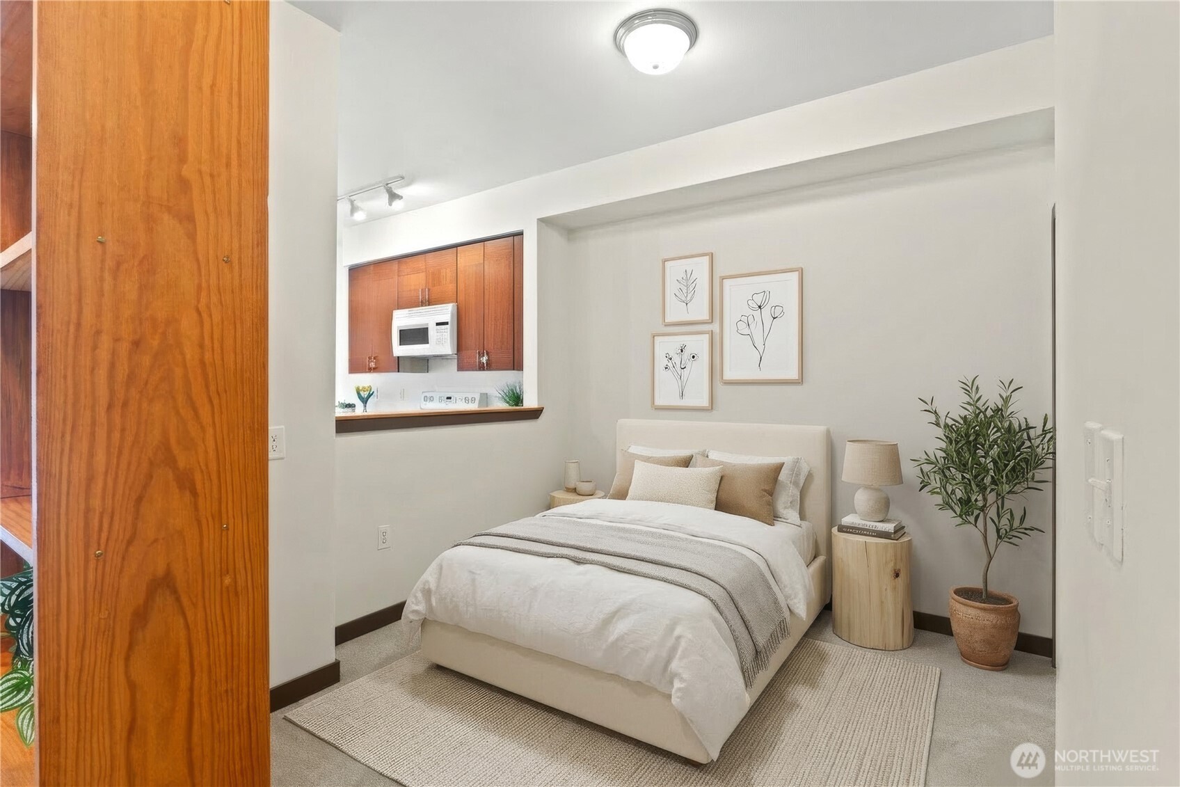 910 Gladstone Street, Unit 103 Bellingham, WA 98229 - Photo 15 of 28 a bedroom with a bed and a potted plant