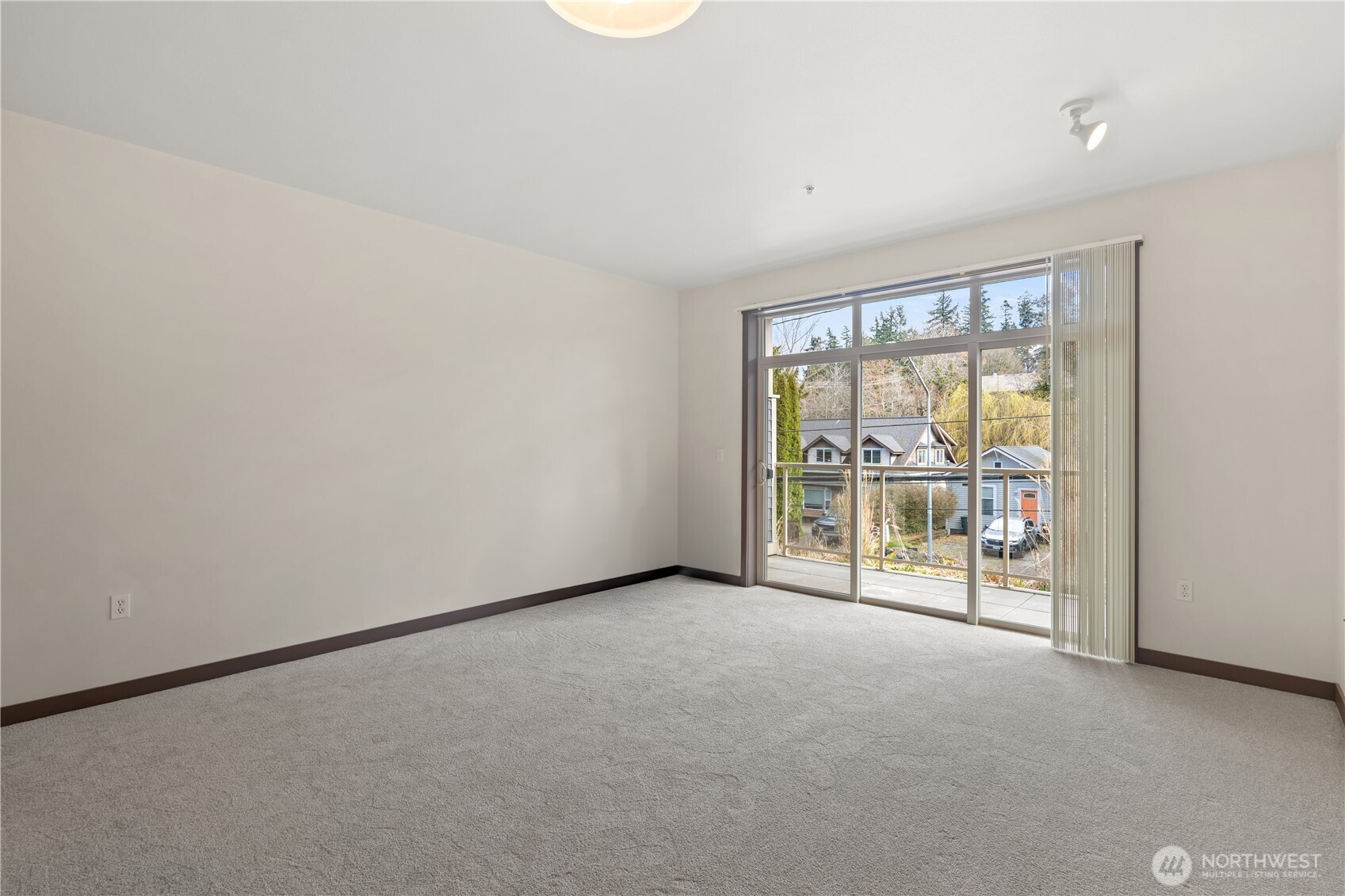 910 Gladstone Street, Unit 103 Bellingham, WA 98229 - Photo 3 of 28 an empty room with floor to ceiling window and an outdoor view