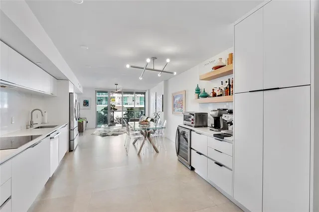 a kitchen with stainless steel appliances granite countertop a refrigerator and a stove top oven