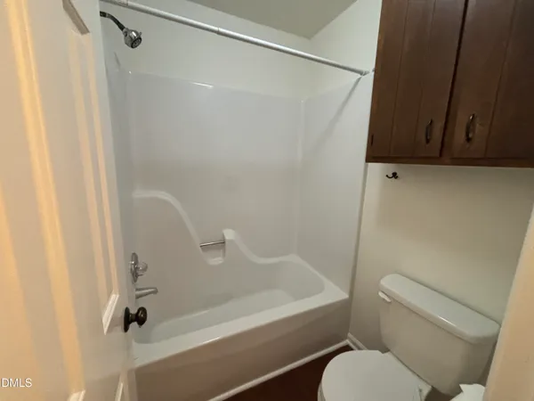 an empty room with a window and a ceiling fan