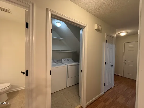 a view of a room with wooden floor and white walls