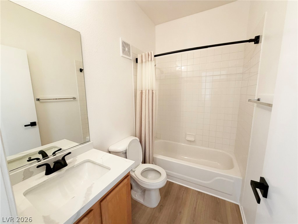 8725 West Flamingo Road, Unit 226 Las Vegas, NV 89147 - Photo 7 of 11 Bathroom with shower / tub combo with curtain, vanity, and light wood finished floors