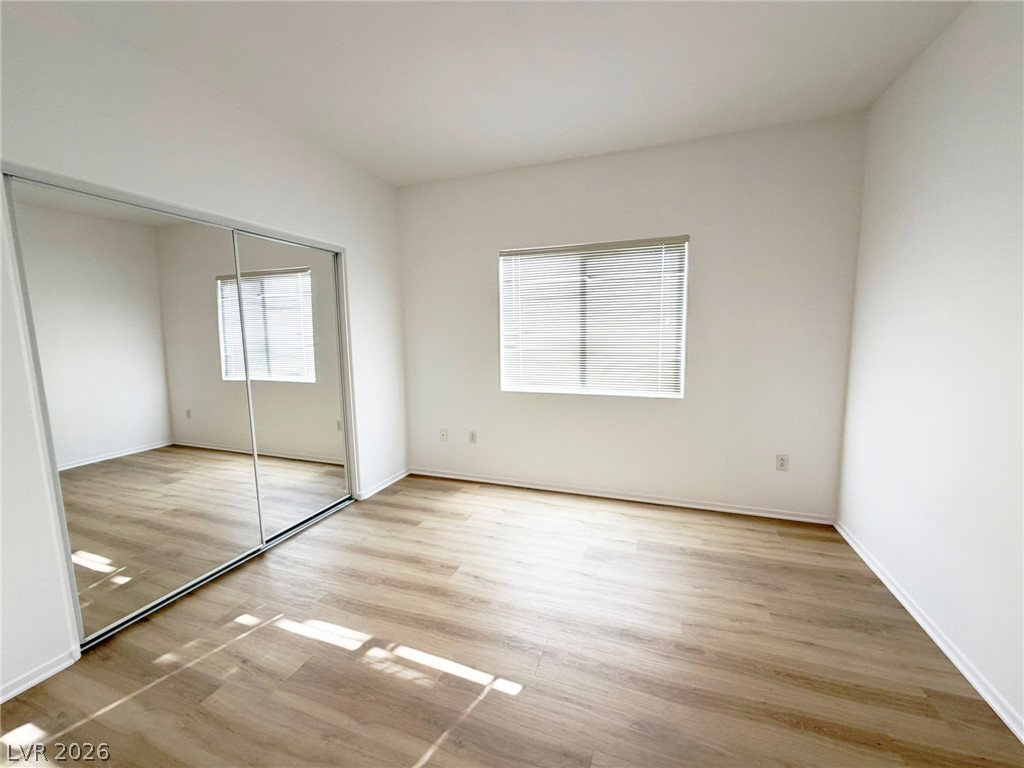 8725 West Flamingo Road, Unit 226 Las Vegas, NV 89147 - Photo 8 of 11 Unfurnished bedroom with light wood-type flooring and a closet