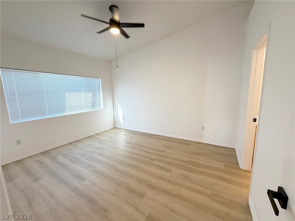 8725 West Flamingo Road, Unit 226 Las Vegas, NV 89147 - Photo 9 of 11 Spare room with light wood finished floors, ceiling fan, and lofted ceiling