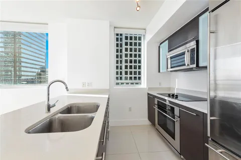 a kitchen with a sink cabinets and stainless steel appliances