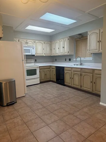 a kitchen with a sink stove and cabinets