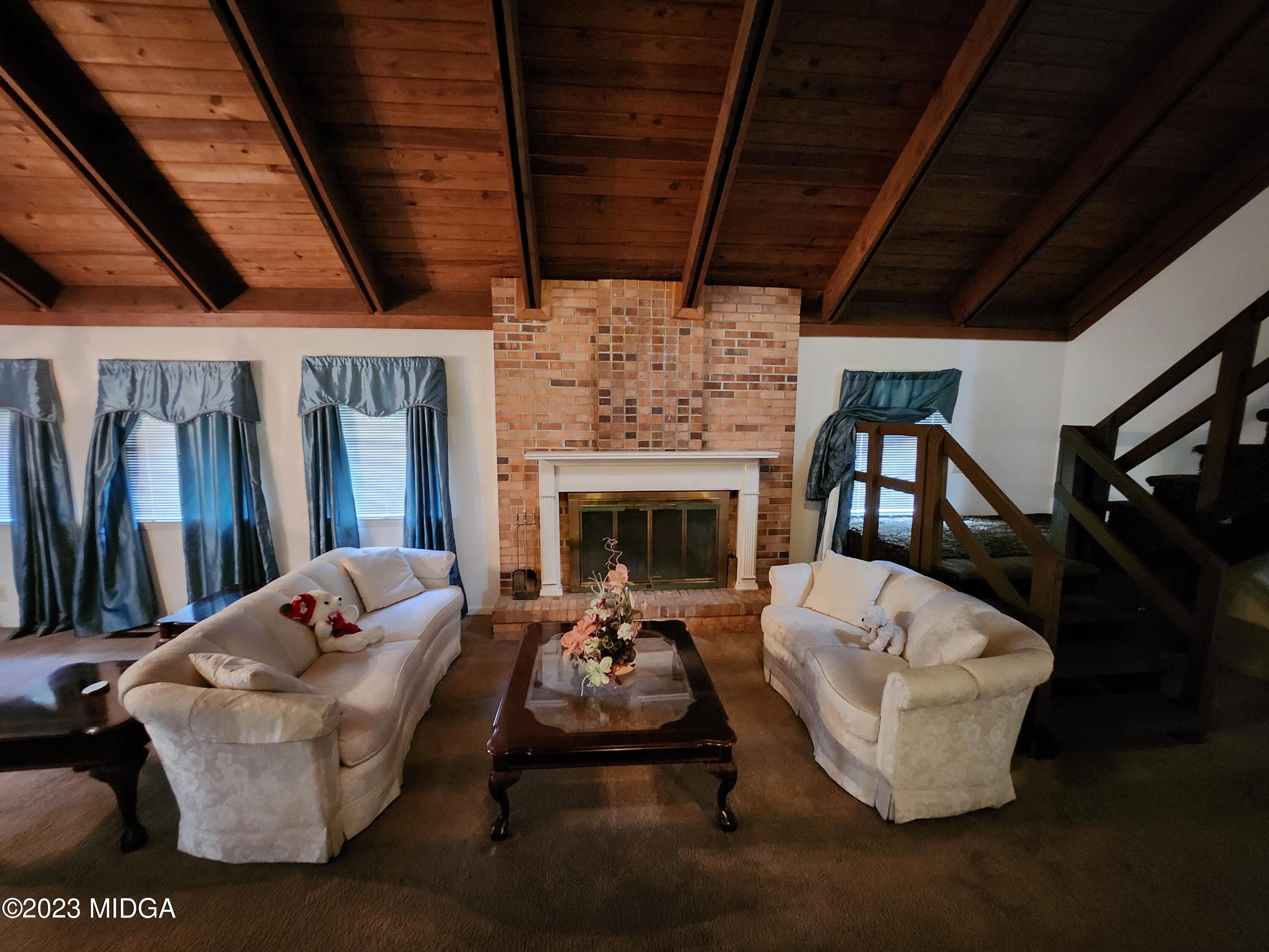 7338 Columbus Road Lizella, GA 31052 - Photo 19 of 33 a living room with furniture fireplace and a flat screen tv