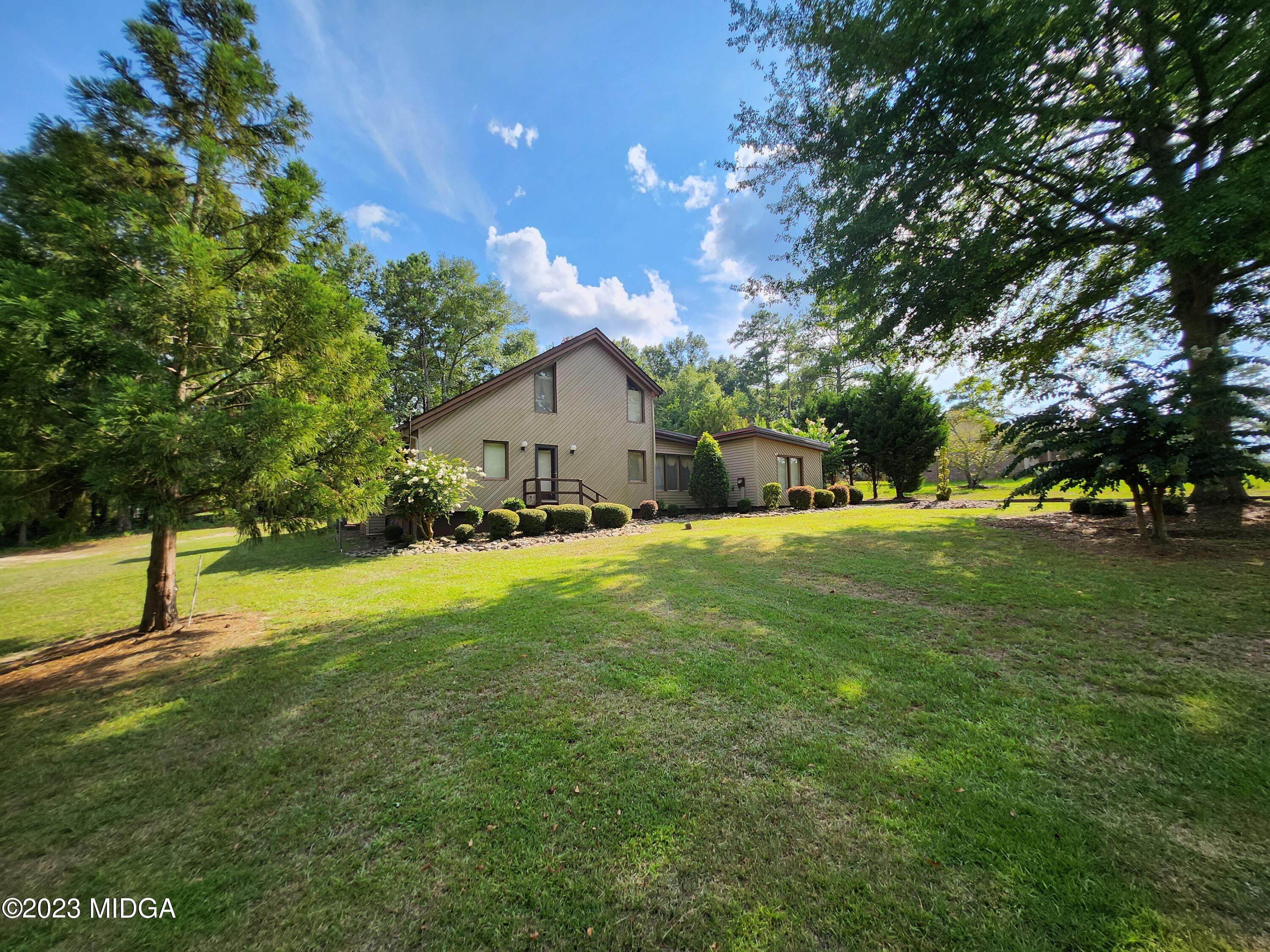 7338 Columbus Road Lizella, GA 31052 - Photo 2 of 33 a view of house with a backyard