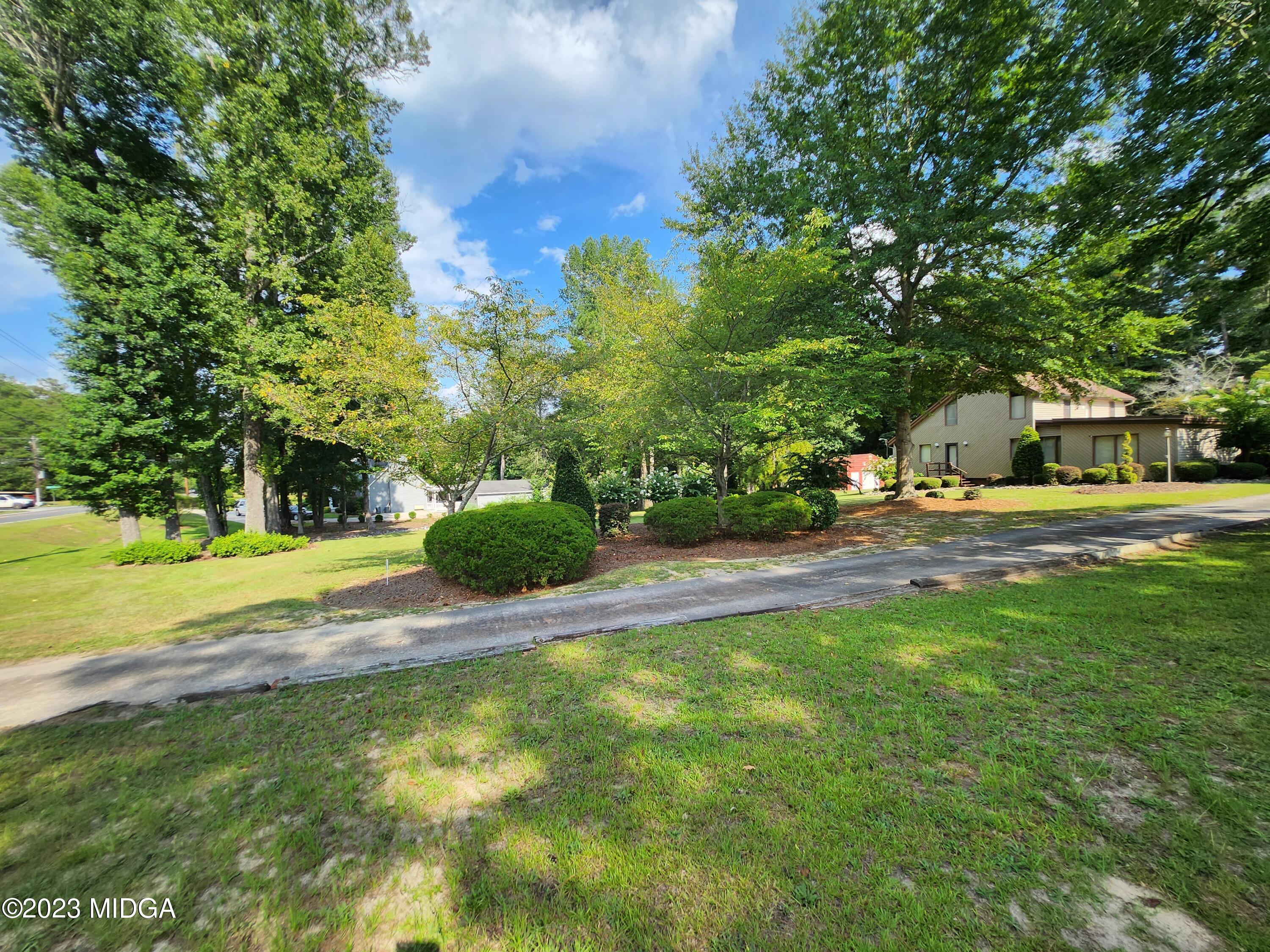 7338 Columbus Road Lizella, GA 31052 - Photo 5 of 33 a view of yard with swimming pool and green space