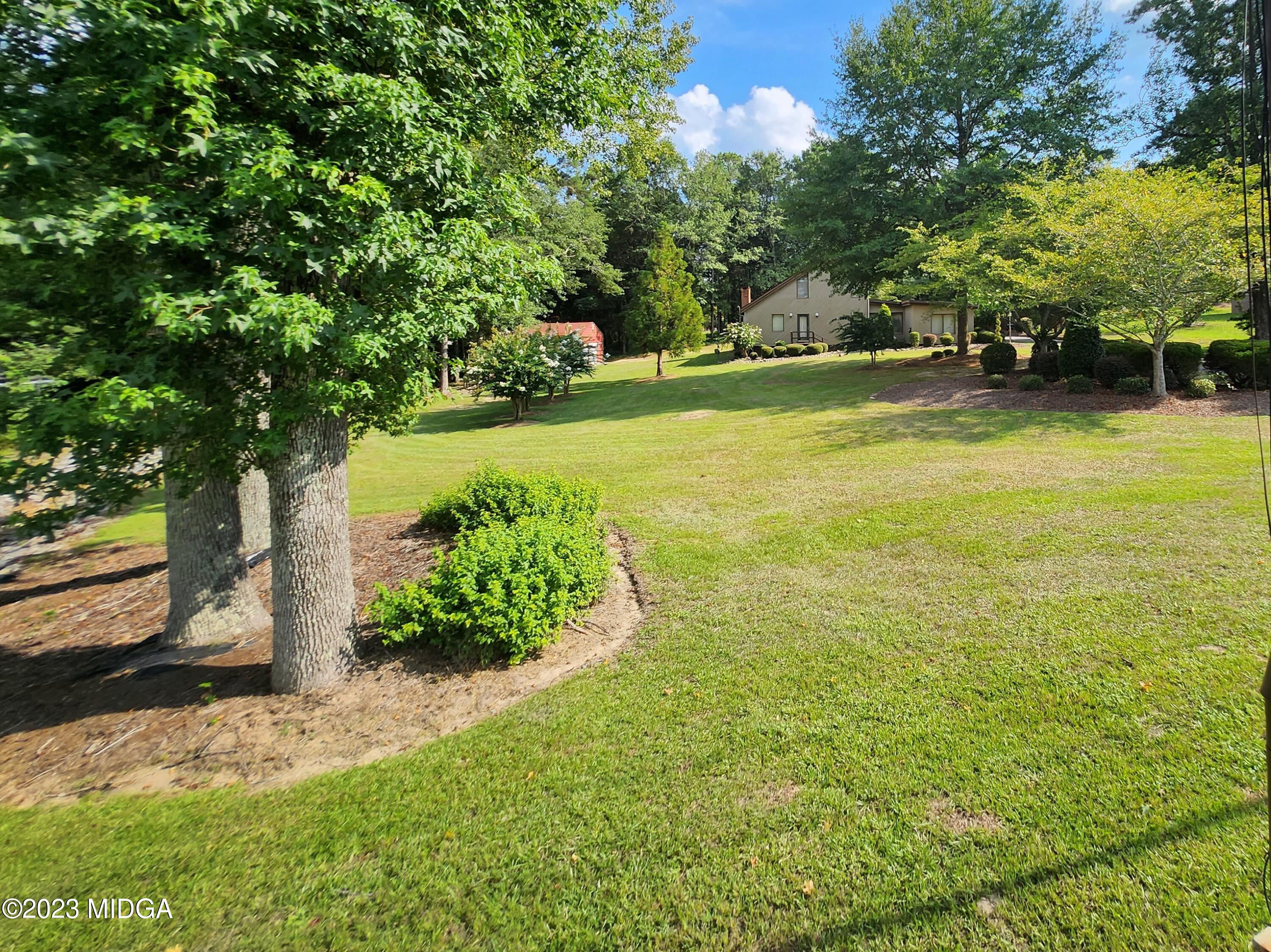 7338 Columbus Road Lizella, GA 31052 - Photo 7 of 33 a view of a yard with an trees