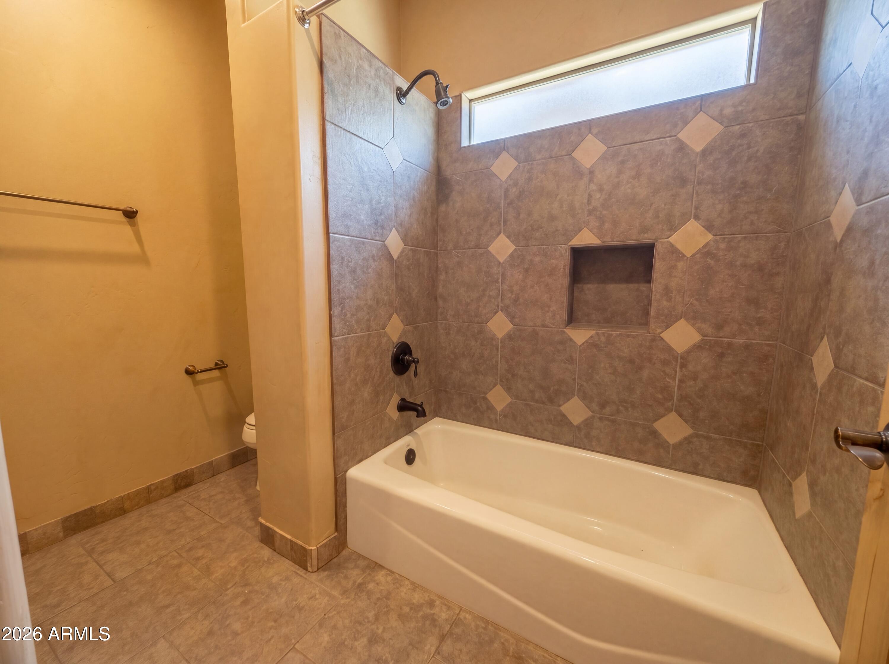 4496 South Kings Ranch Road Gold Canyon, AZ 85118 - Photo 11 of 22 a bathroom with a bathtub