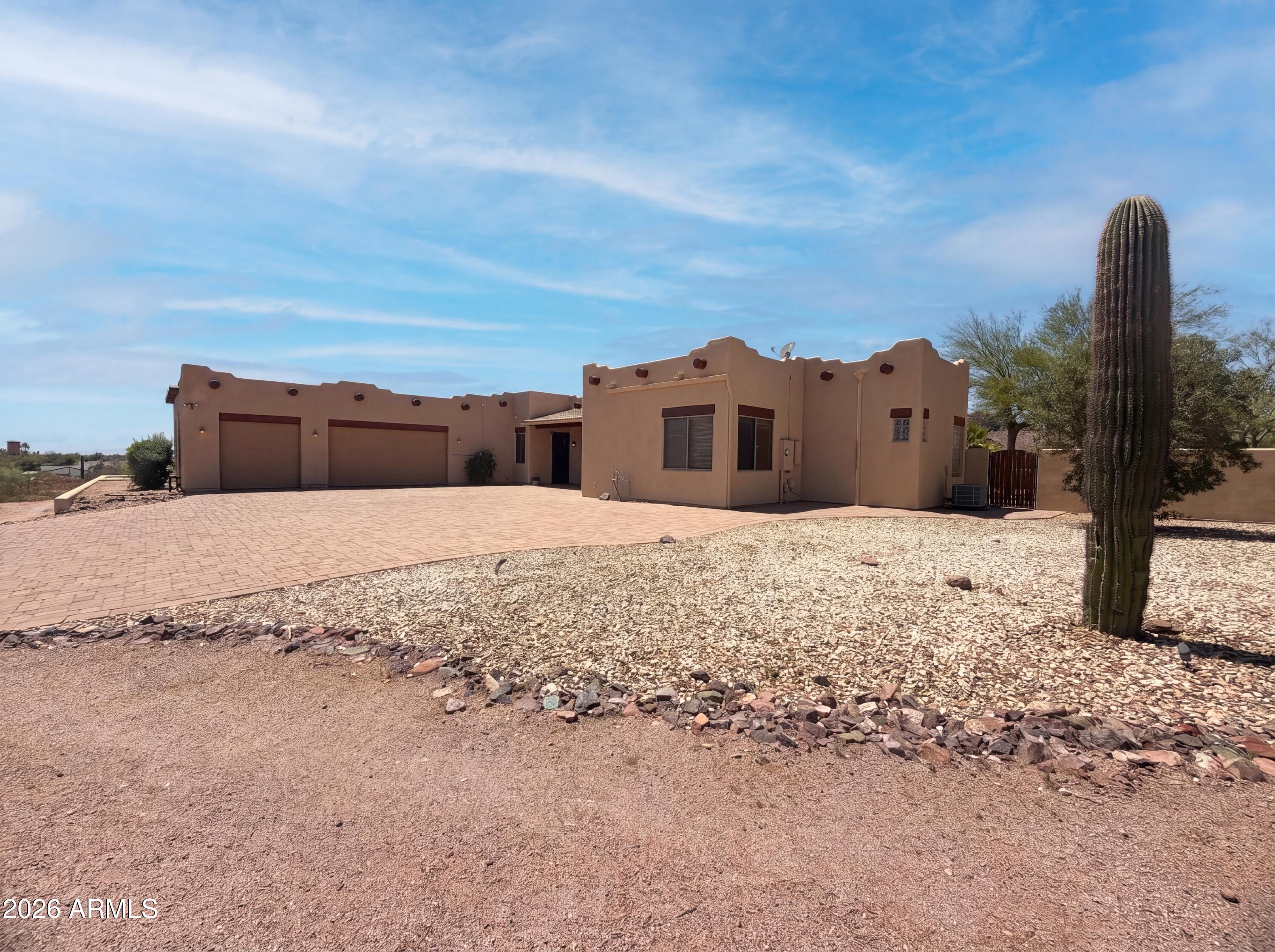 4496 South Kings Ranch Road Gold Canyon, AZ 85118 - Photo 15 of 22 a view of a dry yard with a house