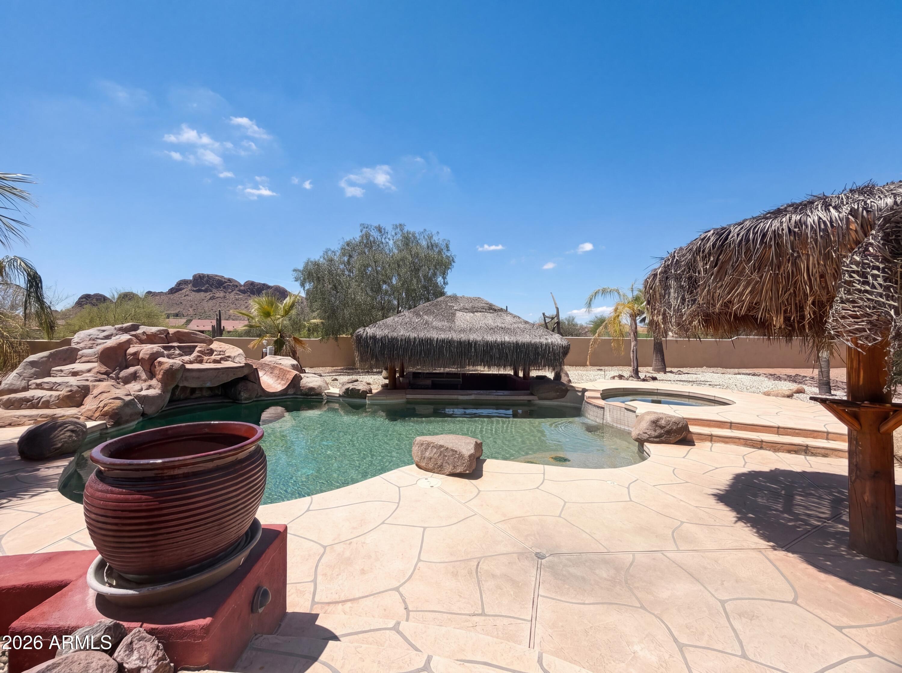 4496 South Kings Ranch Road Gold Canyon, AZ 85118 - Photo 16 of 22 a swimming pool with barbeque oven and outdoor seating