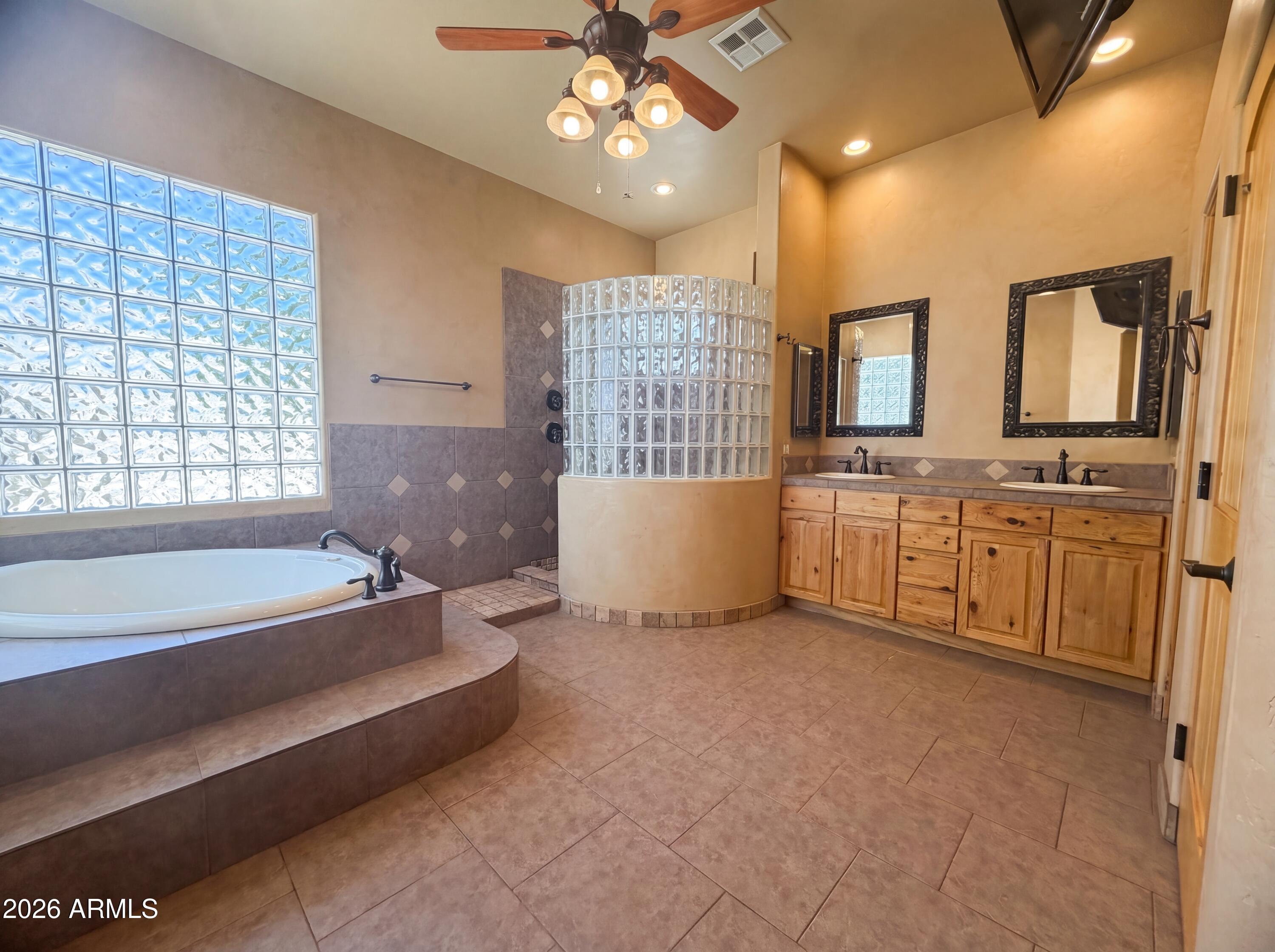 4496 South Kings Ranch Road Gold Canyon, AZ 85118 - Photo 8 of 22 a spacious bathroom with a large tub sink shower and mirror