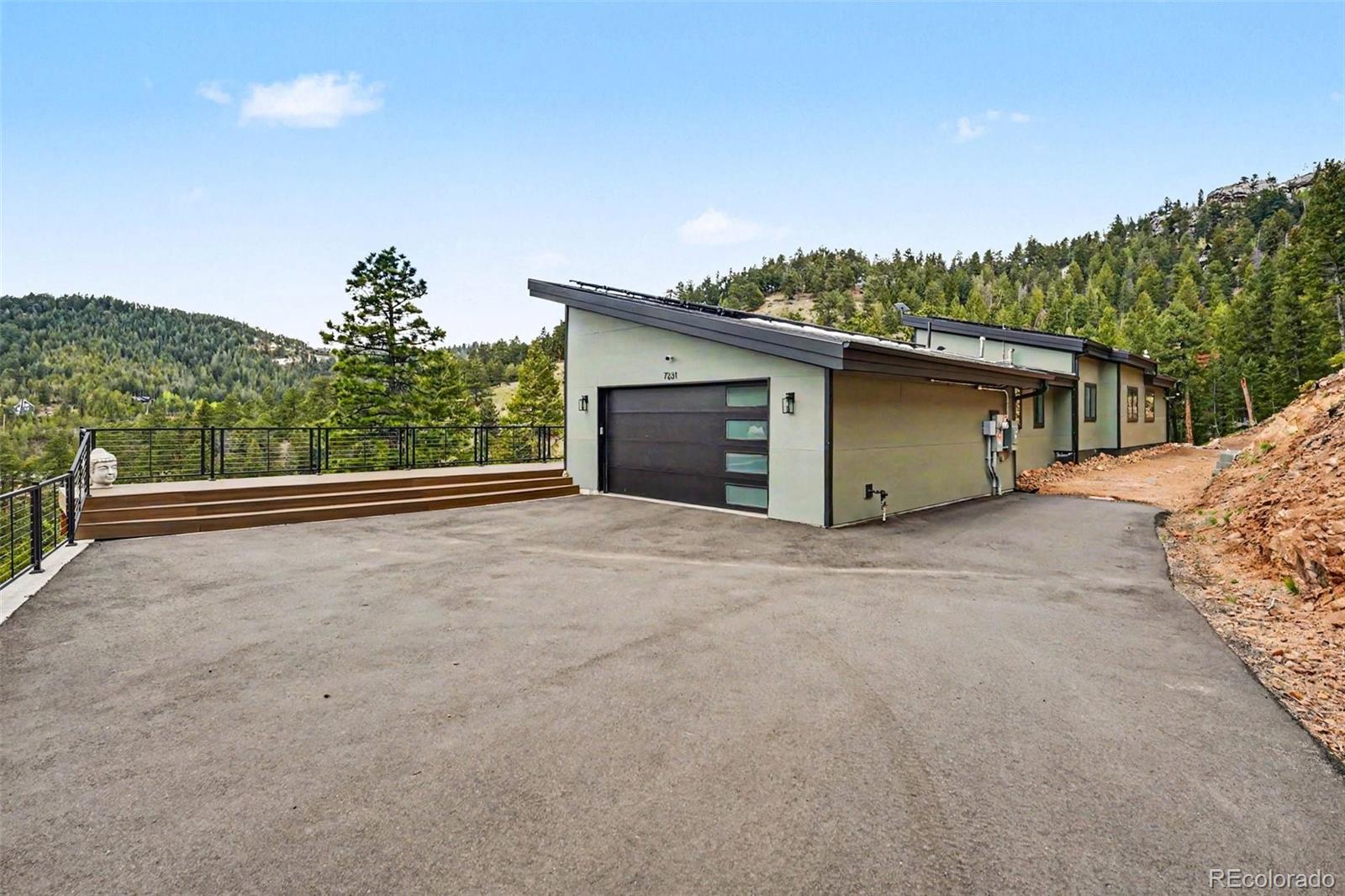7231 Timber Trail Road Evergreen, CO 80439 - Photo 2 of 35 a view of a house with a garage