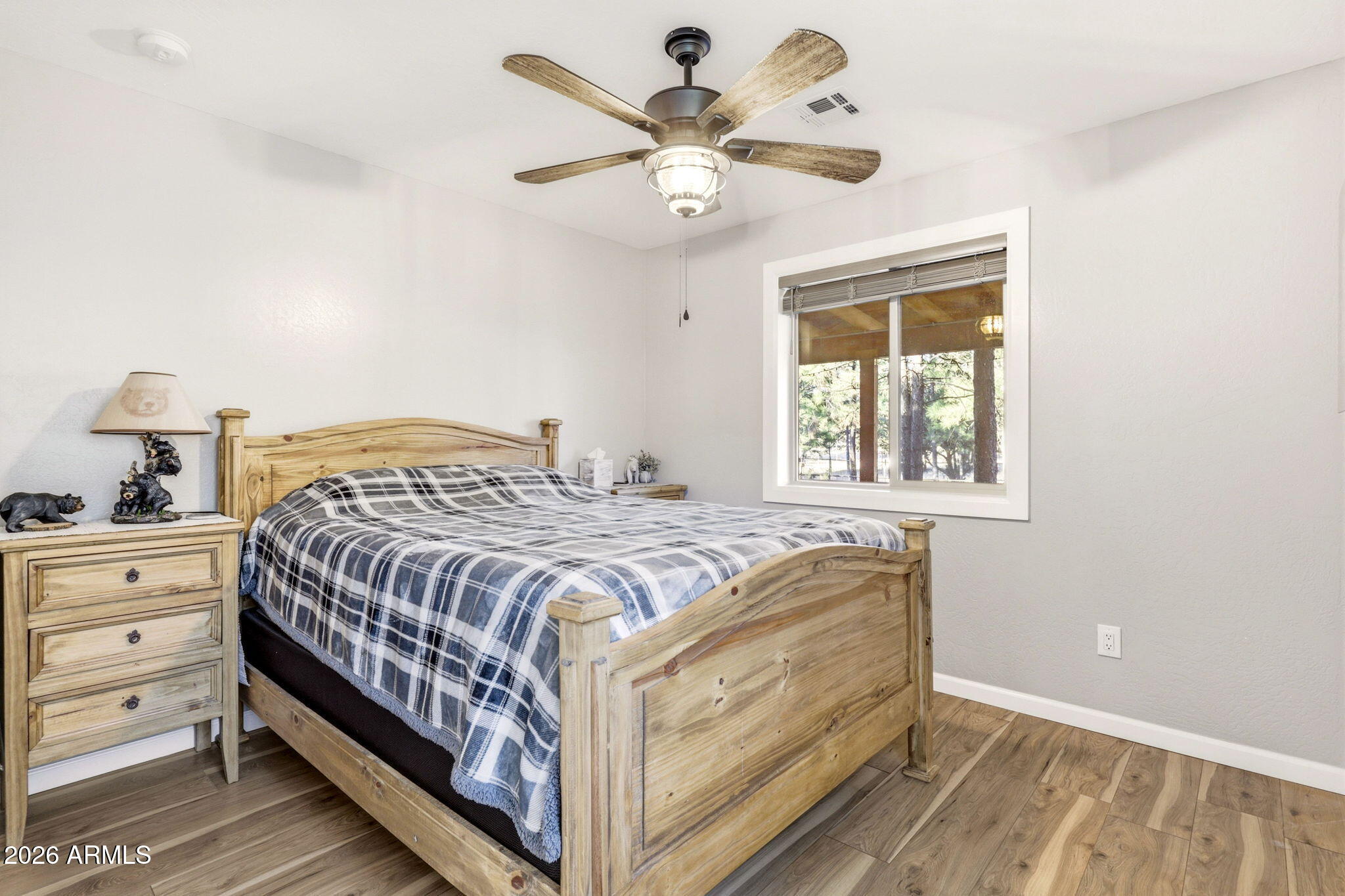 2900 Long Rifle Place Overgaard, AZ 85933 - Photo 17 of 35 a bedroom with a bed and a chandelier