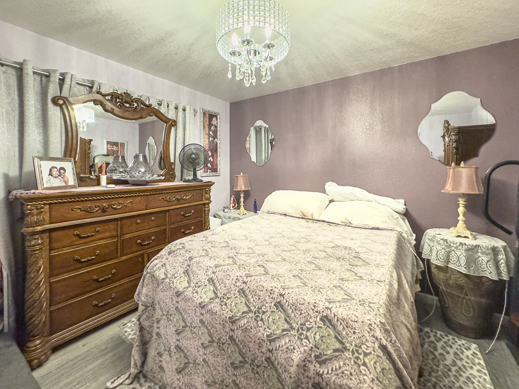89 Box Turtle Lane Murphy, NC 28906 - Photo 19 of 51 a bedroom with a bed and a chandelier