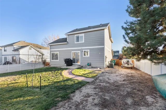 a view of a house with backyard and sitting area