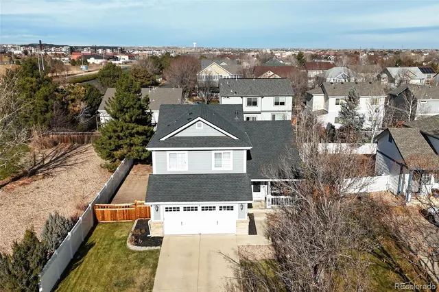 an aerial view of a house with a yard