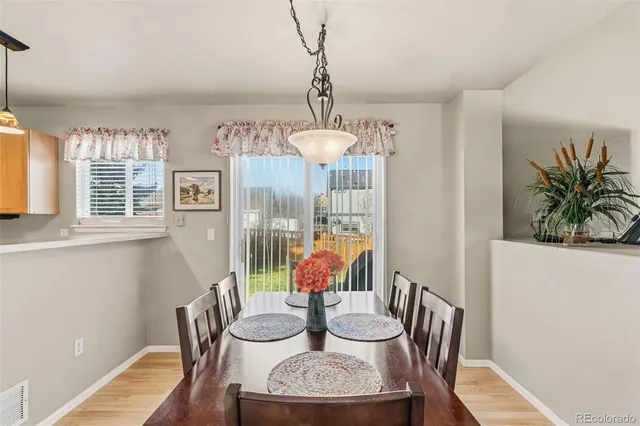 a view of a dining room with furniture window and wooden floor