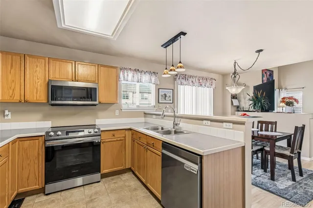 a kitchen with a sink stove and microwave