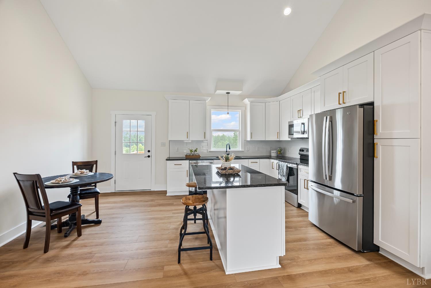 2 Hales Ford Road Moneta, VA 24121 - Photo 10 of 39 a kitchen with stainless steel appliances granite countertop a refrigerator a stove a sink a dining table and chairs with wooden floor