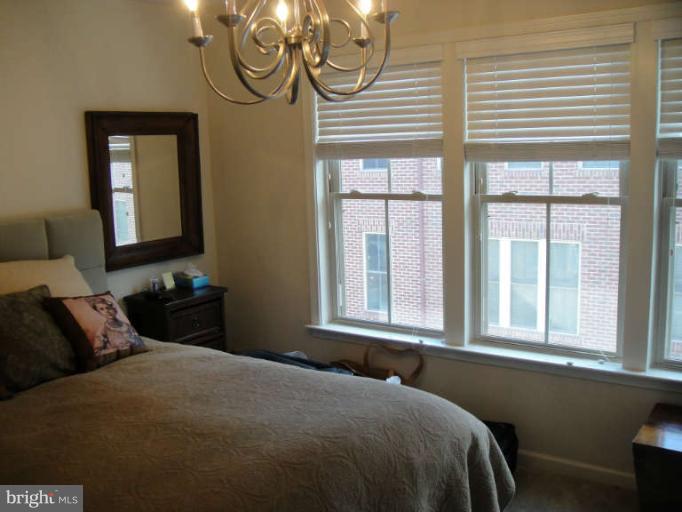 3405 Kemper Road Arlington, VA 22206 - Photo 15 of 30 a bedroom with a bed and window with chair
