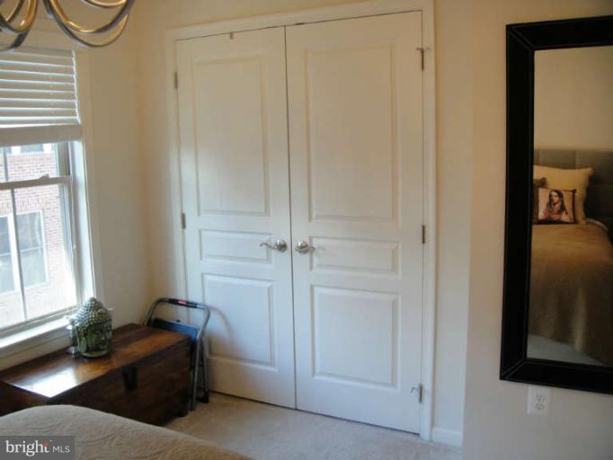 3405 Kemper Road Arlington, VA 22206 - Photo 16 of 30 a bedroom with a bed and a mirror