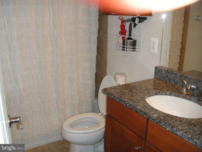 3405 Kemper Road Arlington, VA 22206 - Photo 18 of 30 a bathroom with a granite countertop sink and a mirror
