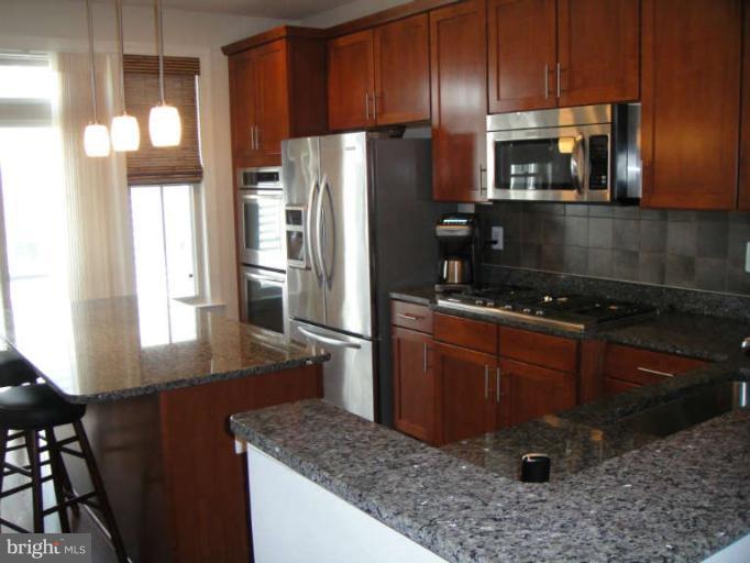 3405 Kemper Road Arlington, VA 22206 - Photo 4 of 30 a kitchen with a refrigerator and a stove