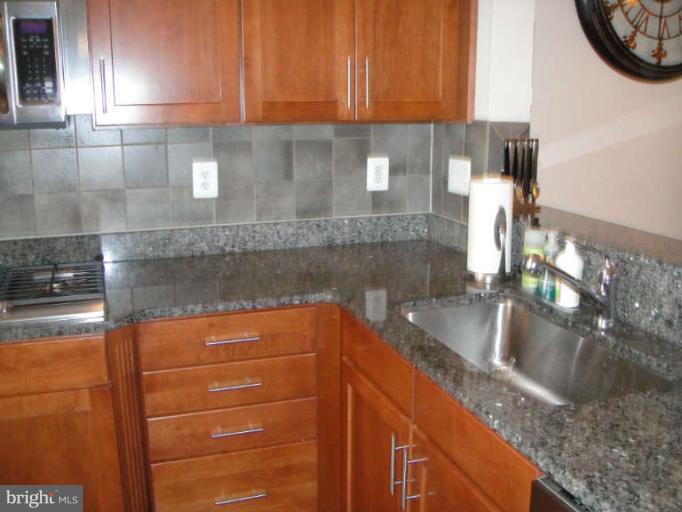 3405 Kemper Road Arlington, VA 22206 - Photo 6 of 30 a kitchen with granite countertop a sink a stove and cabinets