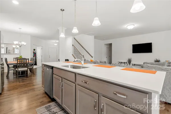 a spacious kitchen with stainless steel appliances granite countertop a sink and a stove